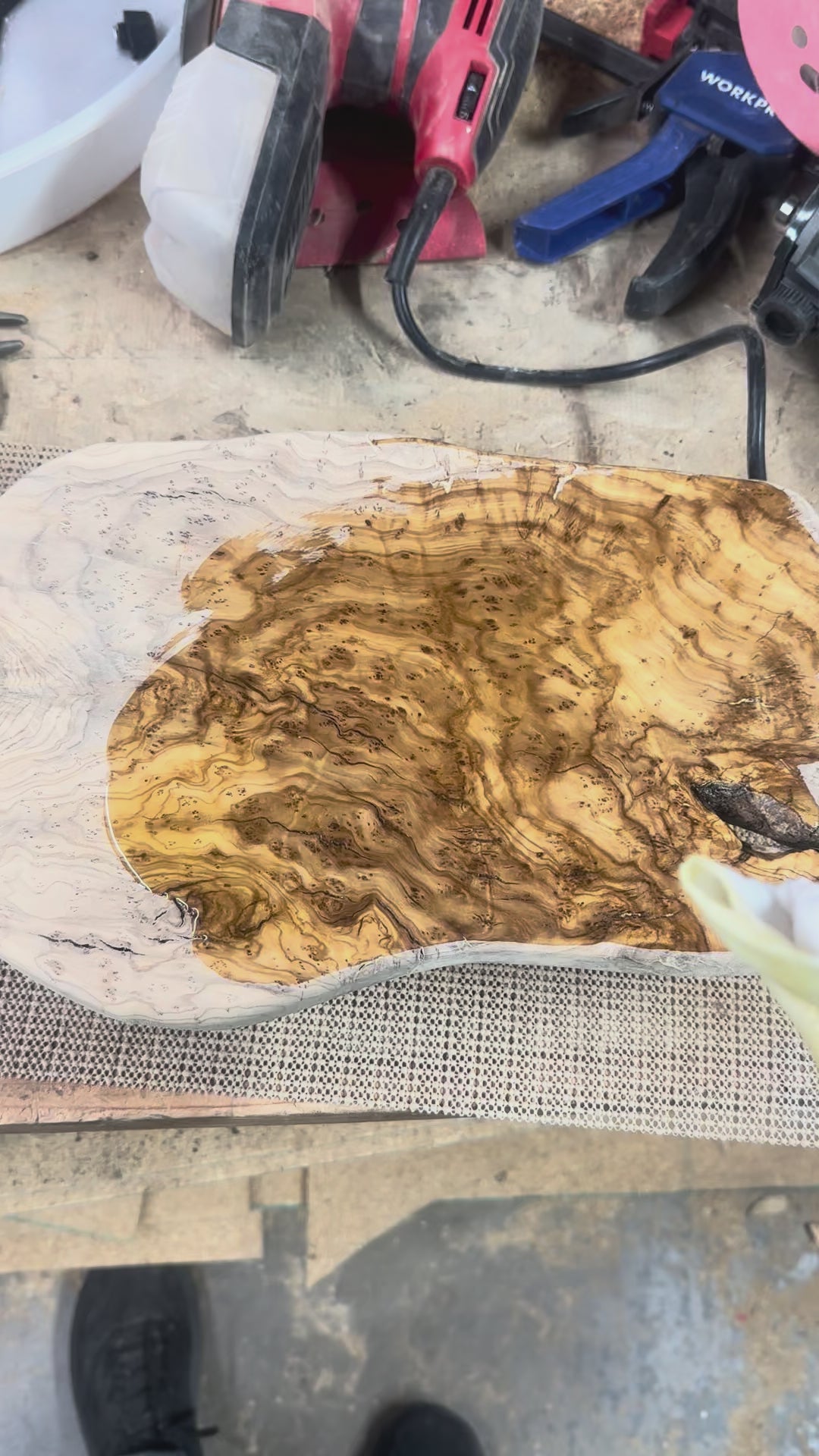 Applying finish to olive wood charcuterie board